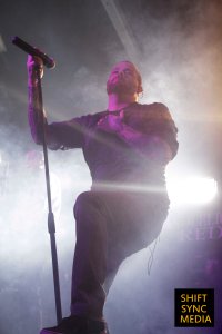 Candlelight Red's Vocalist and Front-Man basking in the glow of a stage light at the Ace of spades venue in Sacramento, CA