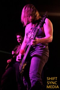 Nonpoint's Adam Wolosyzn the Bass player in front, while Dave Lizzio Guitar player for the band is in the background on stage at the Ace of Spades venue in Sacramento, CA